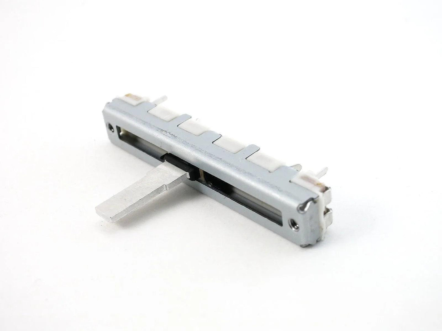 Close-up of Casio FZ-1 slide potentiometer synthesizer part on white background