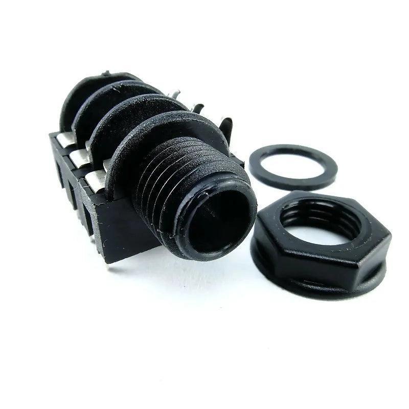 Close-up of black stereo phone jack connector with mounting nut and washer on white background