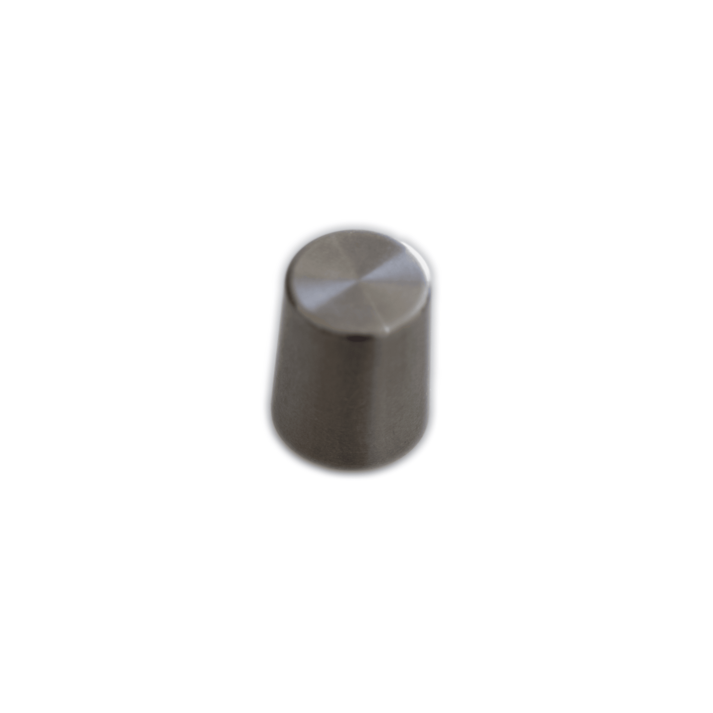 A Waldorf STVC knob, a small, cylindrical stainless steel object with a slightly convex top resembling a button or knob, set against a white background. The sides are smooth and the overall surface is reflective and metallic, without indicator markings.