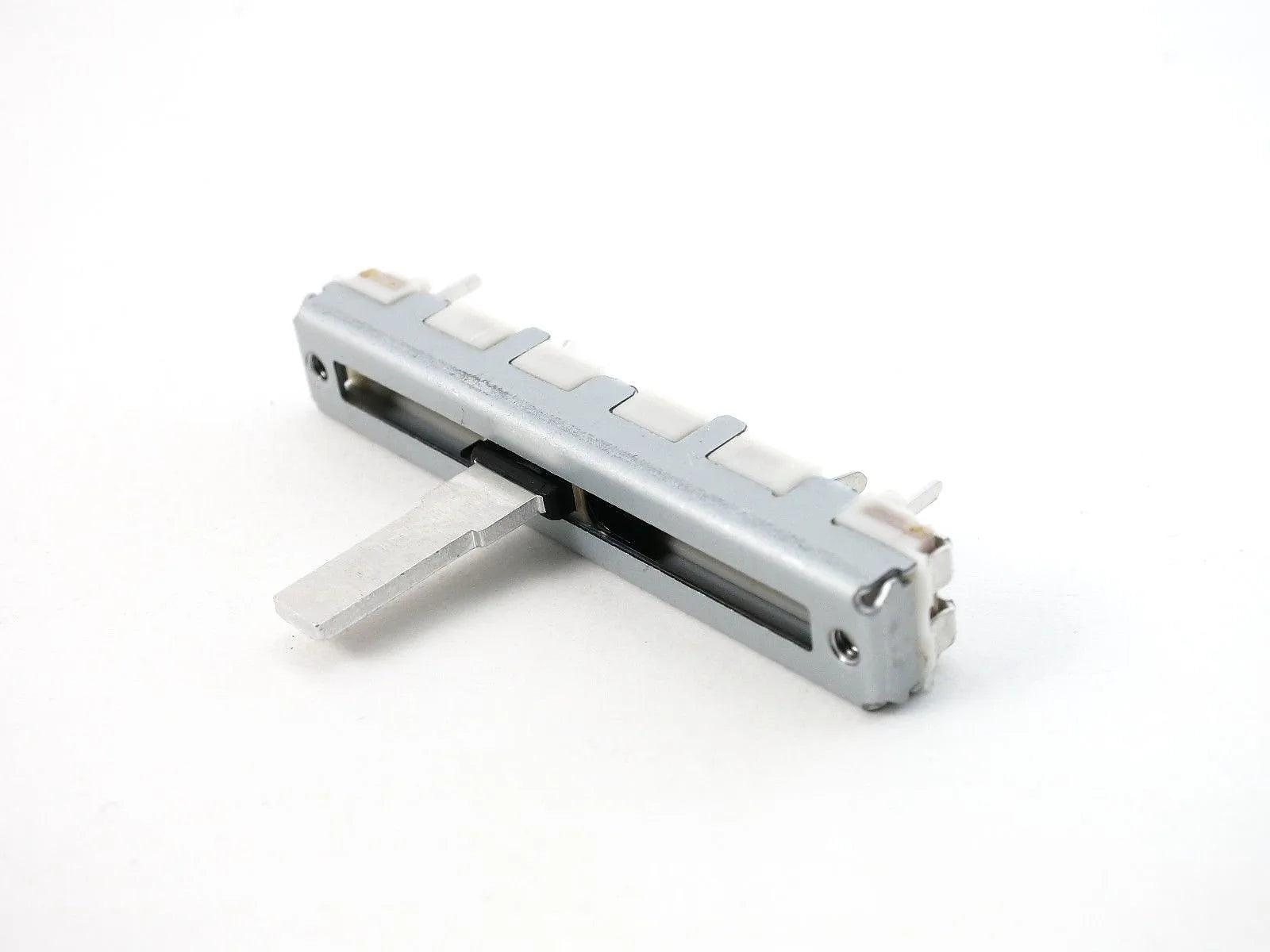 Close-up of Casio FZ-1 slide potentiometer synthesizer part on white background
