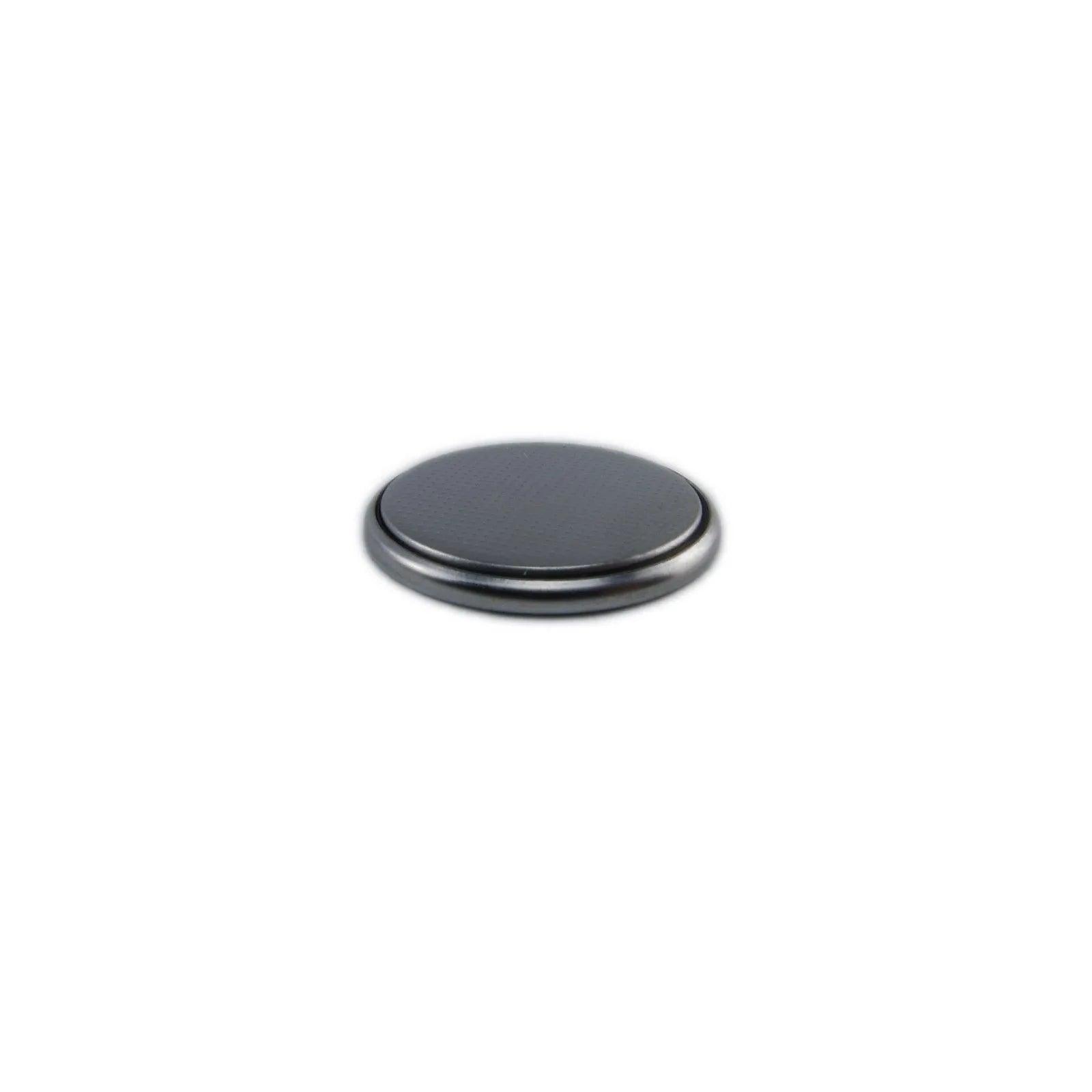 Close-up of a small round silver coin cell battery for electronics and synthesizers