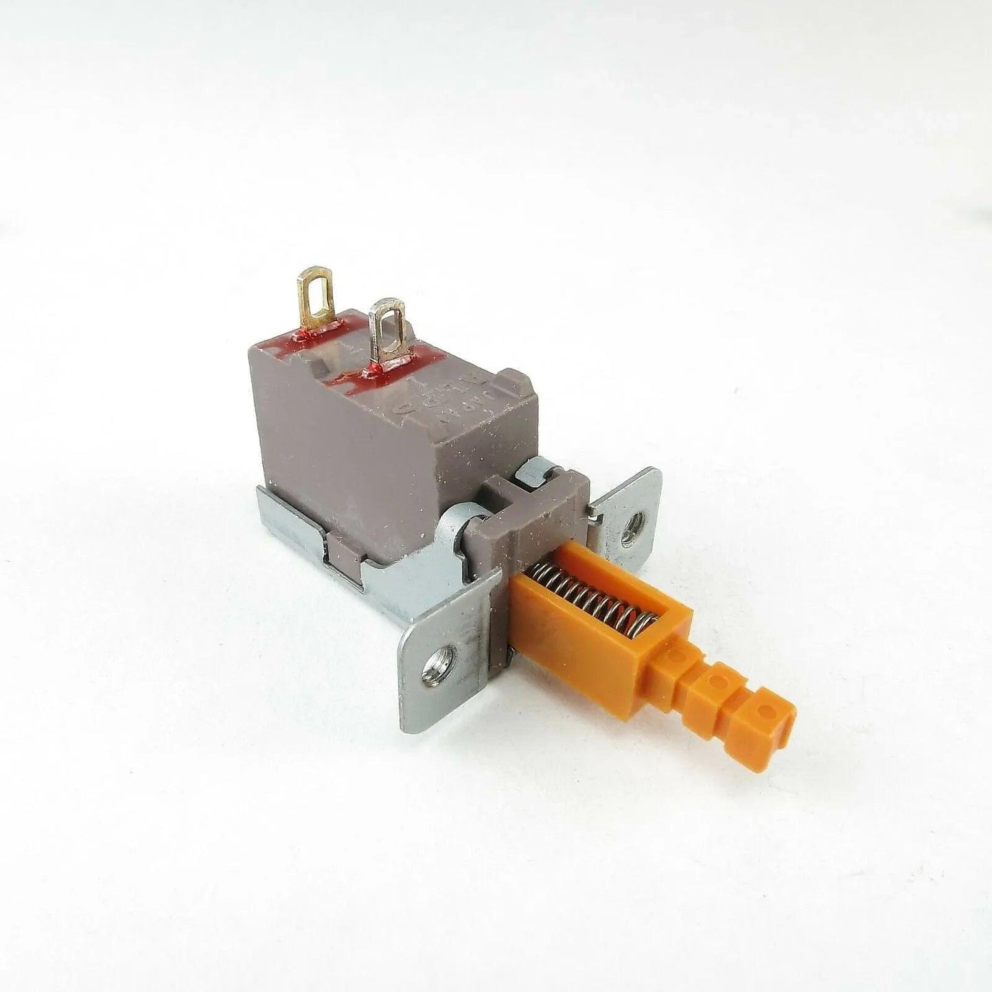 Korg C303 C505 synthesizer power switch with orange plunger and spring on white background