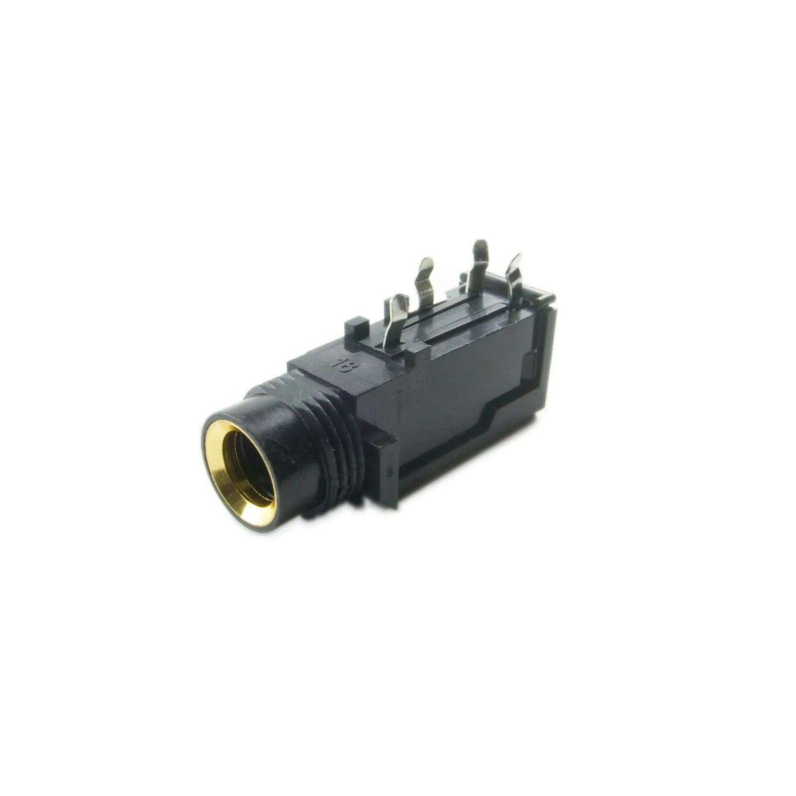 Close-up of a black and gold phone jack connector for synthesizer parts on white background