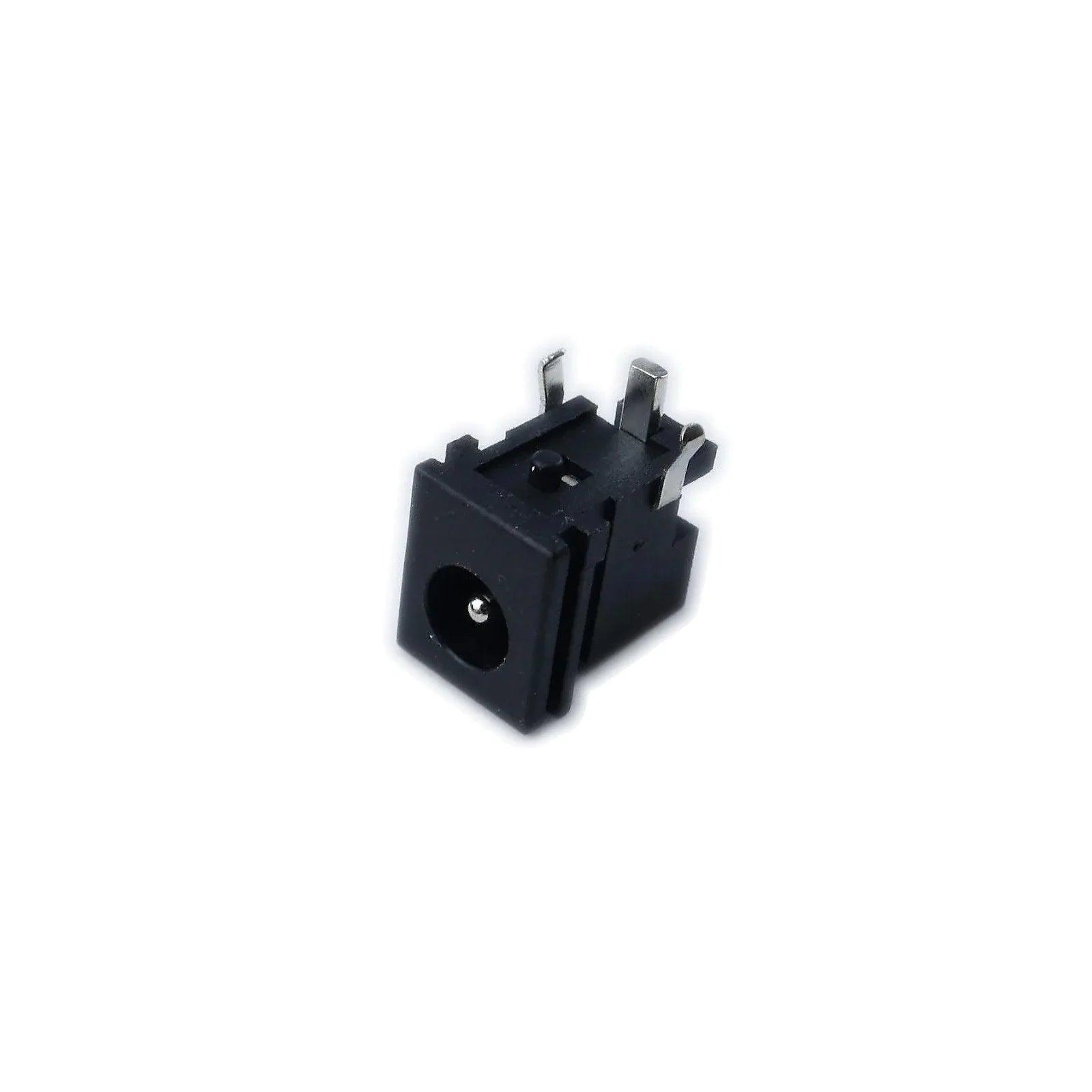 Black Korg Kross 2 61 power input jack connector with metal pins on white background