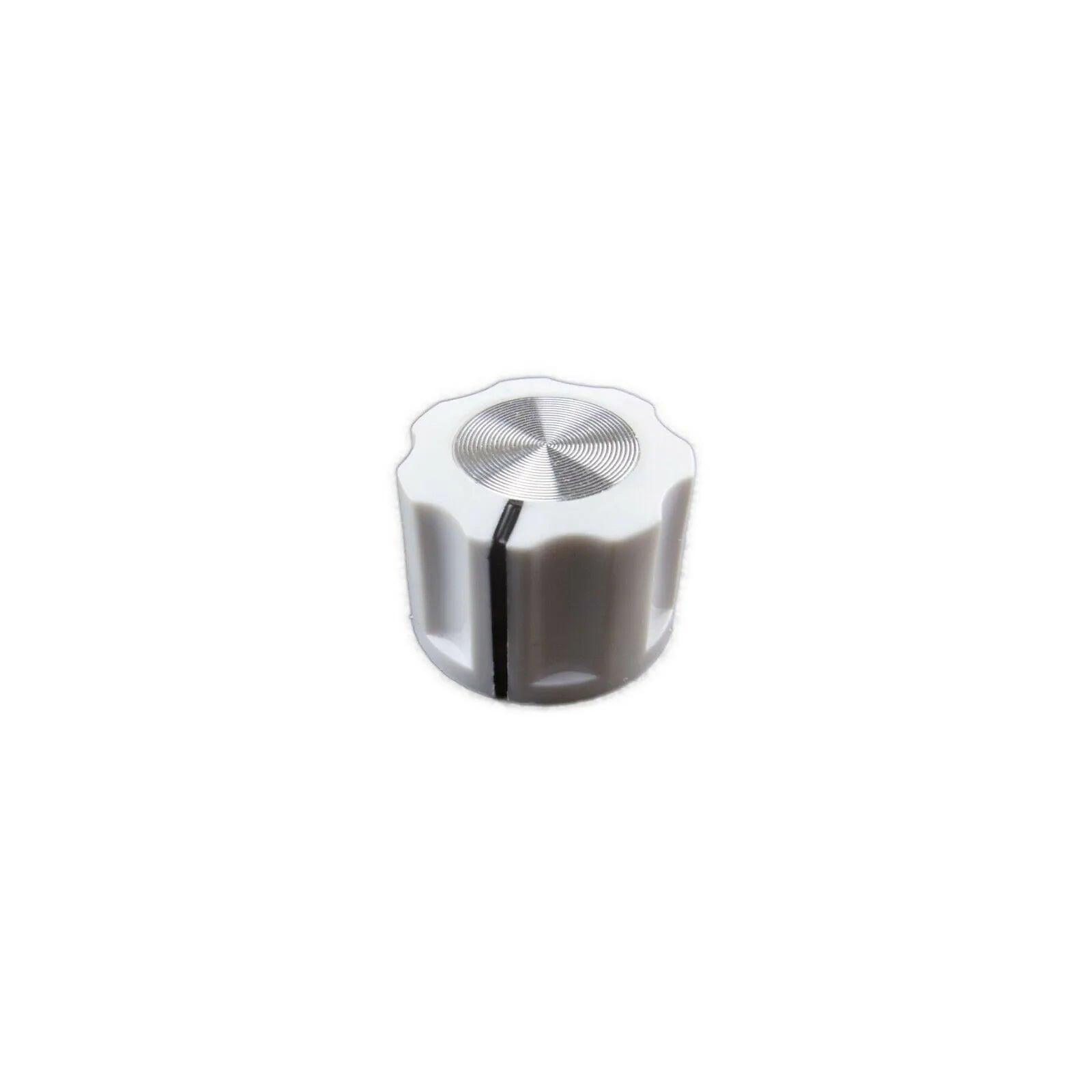 White knob with textured silver top and black indicator line for synthesizer control