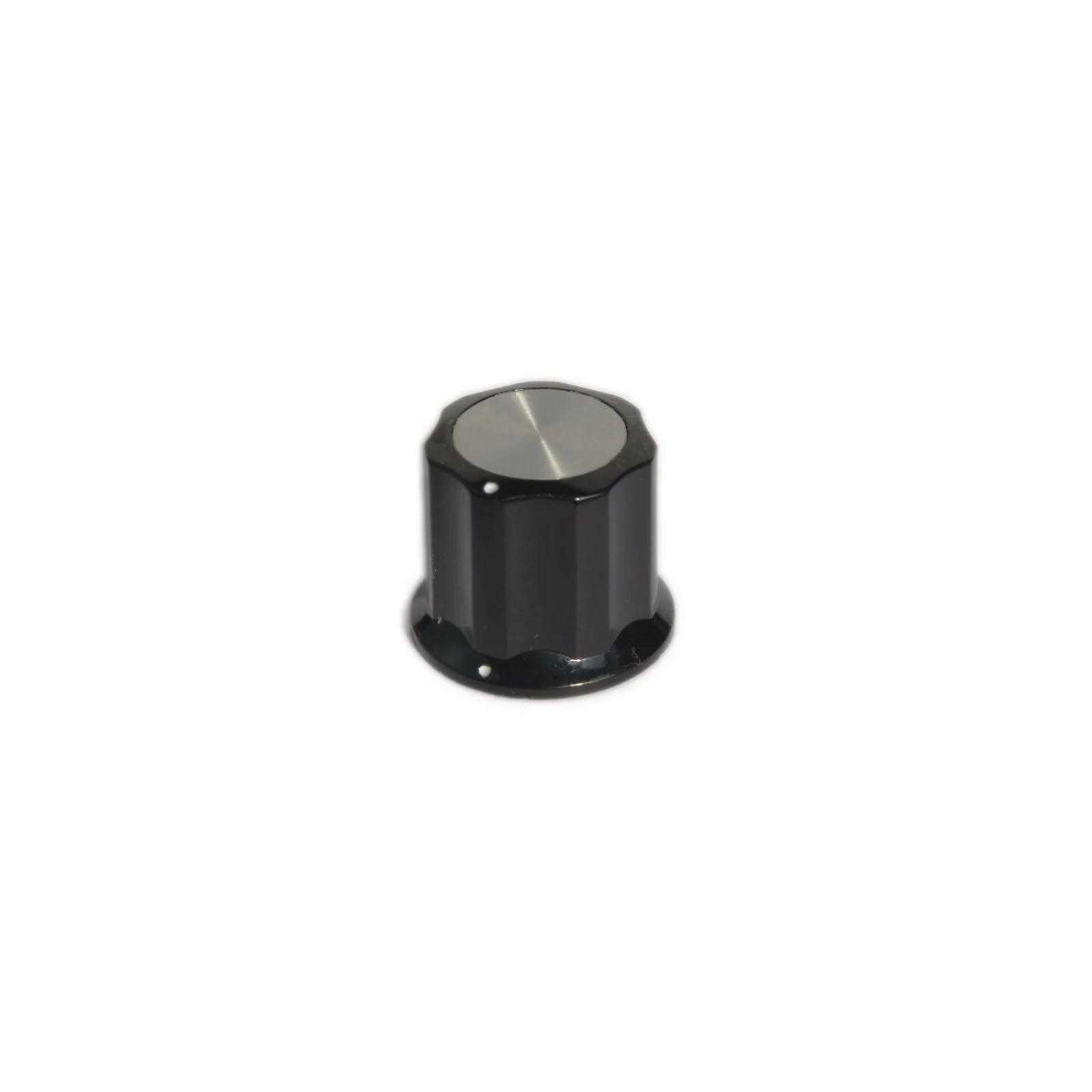 Black Moog synthesizer knob with silver top and white indicator dots on white background