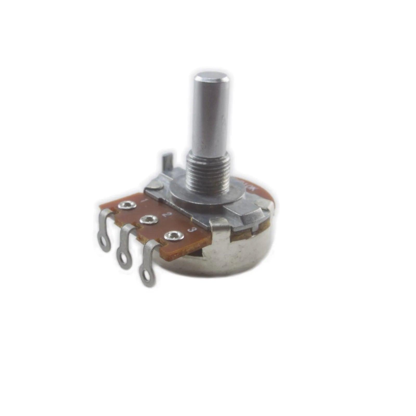 Close-up of metal rotary potentiometer with three pins on white background
