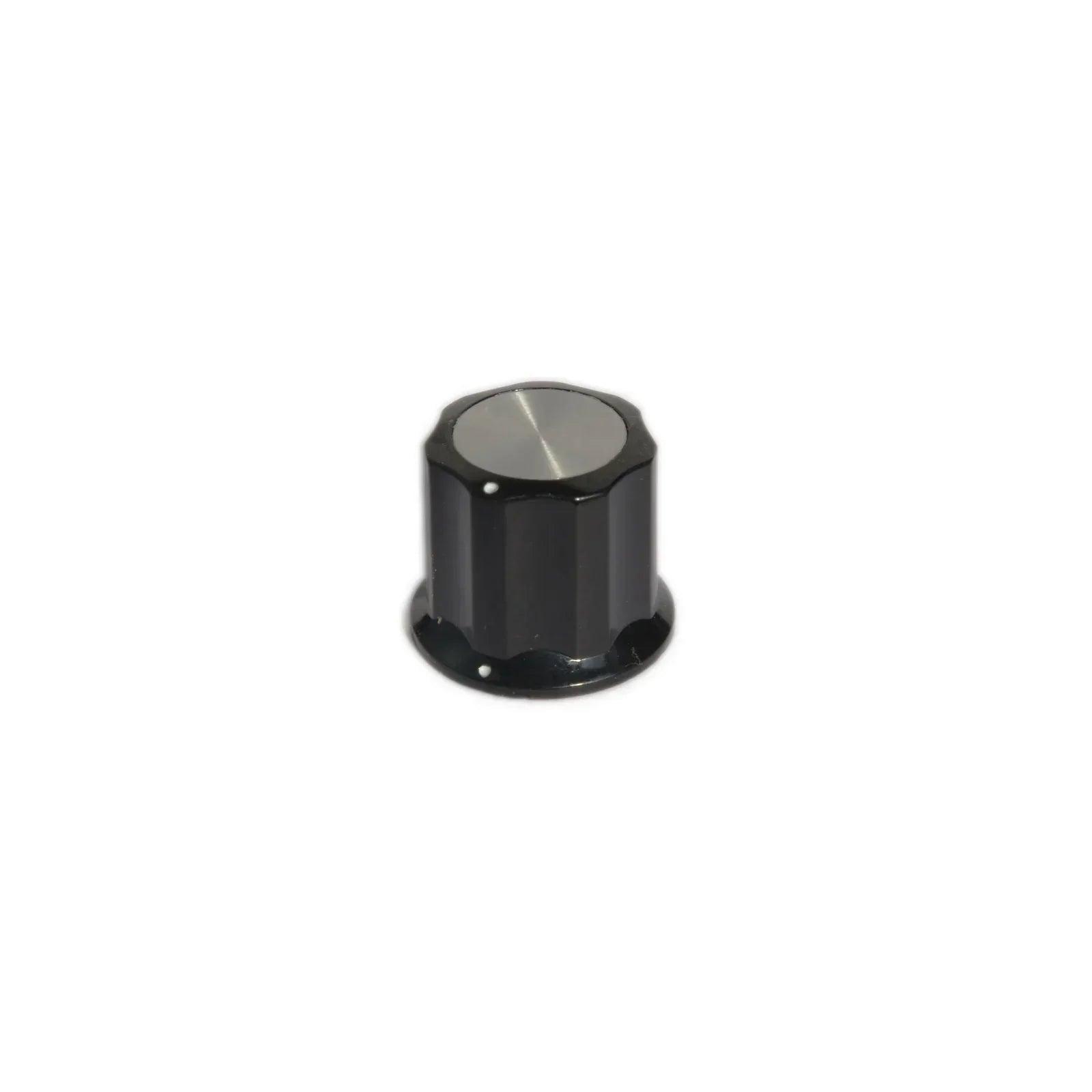 Black knob with silver top and small white indicator dots for synthesizer control