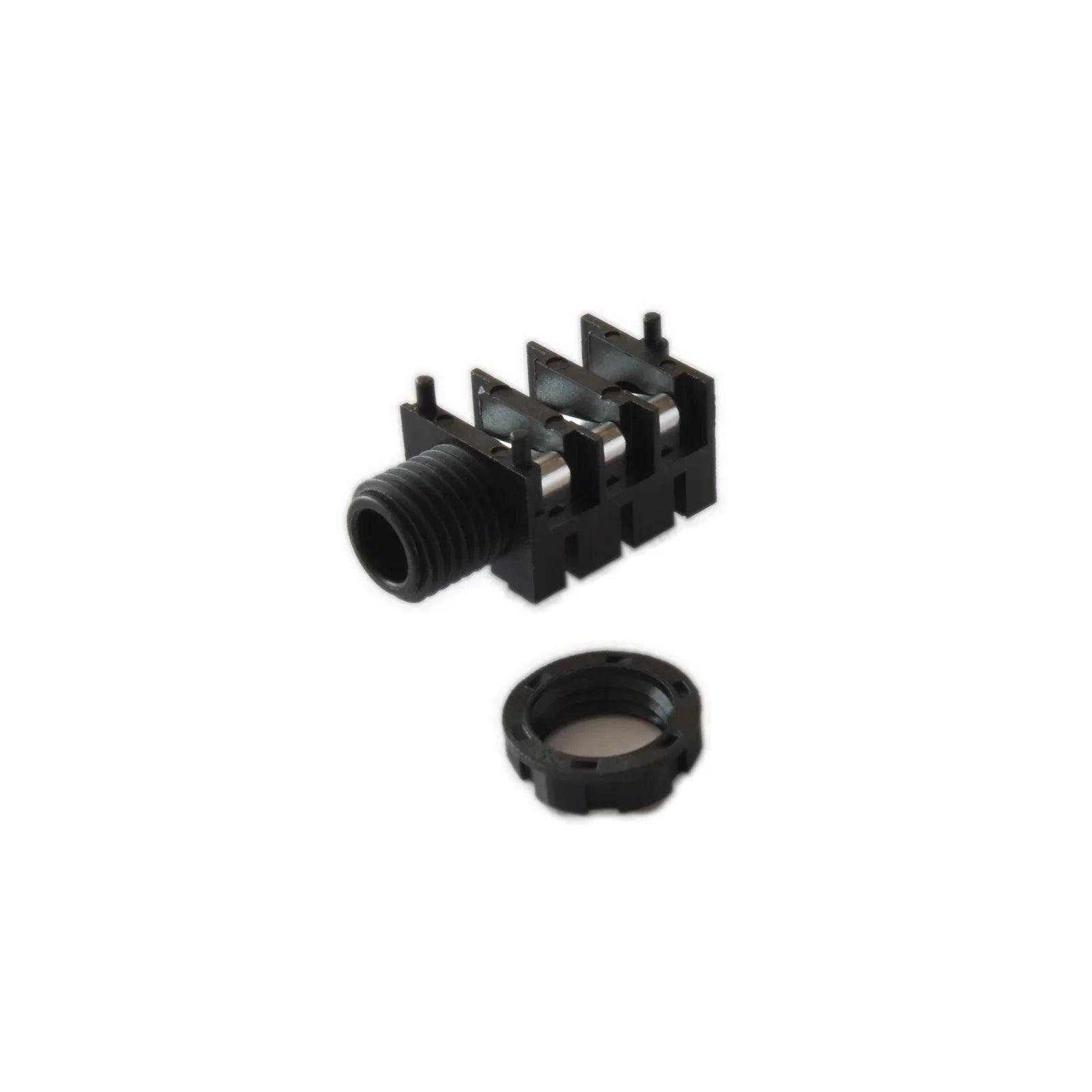 Black Waldorf M-Phone jack synthesizer component and ring on white background