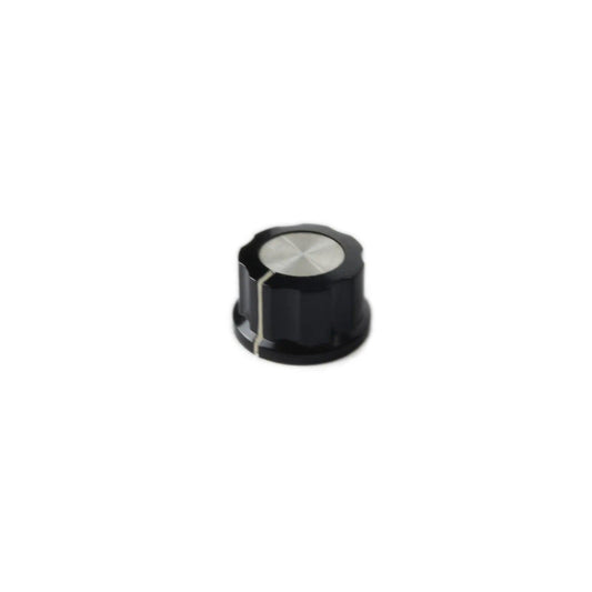 Small black synthesizer knob with silver metal top and white alignment line on white background